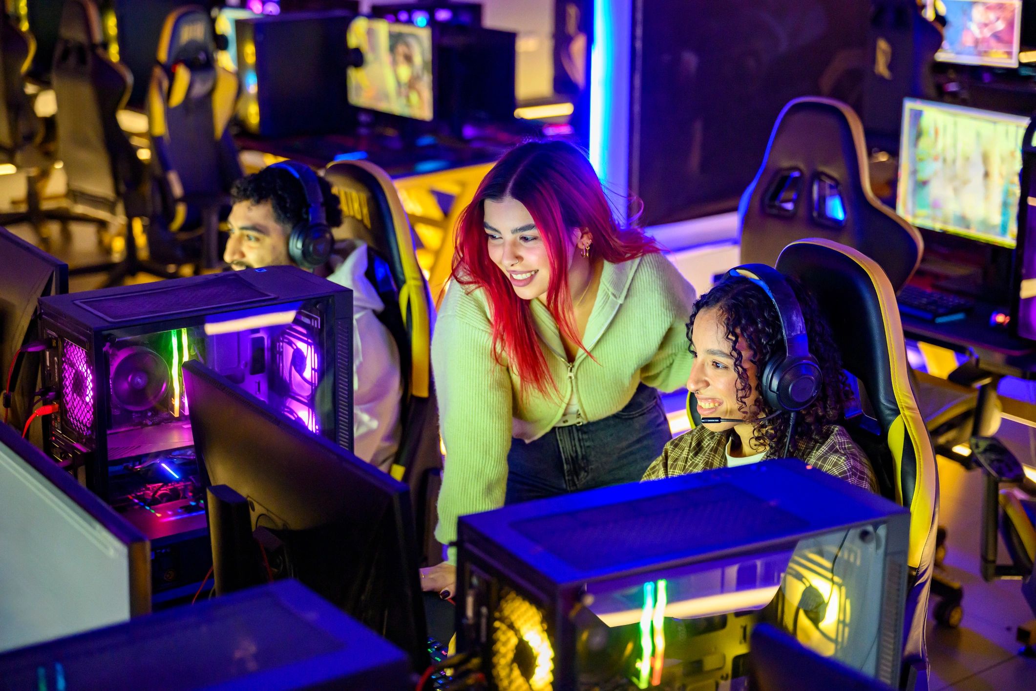 Gamers enjoying a neon-lit gaming session together